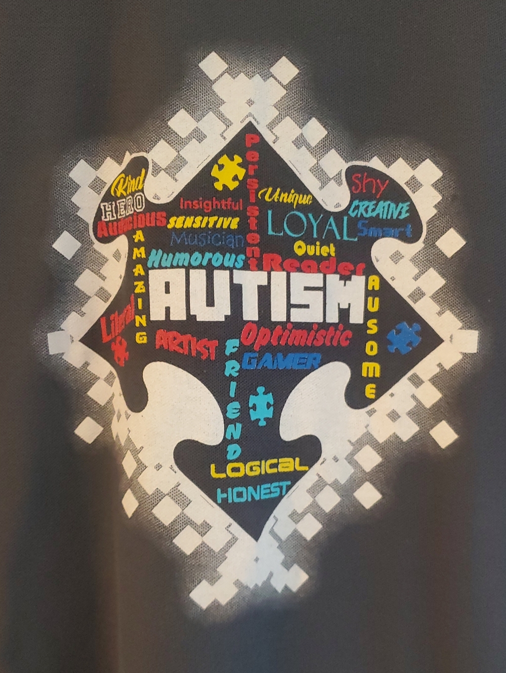 Port Authority Black Tee with Multicolor Autism Puzzle Heart Graphic